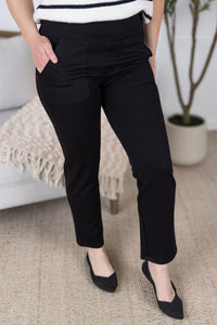 Person wearing black pants and black shoes in a casual setting