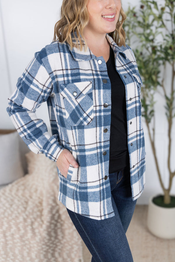 Woman wearing a blue and white plaid jacket indoors