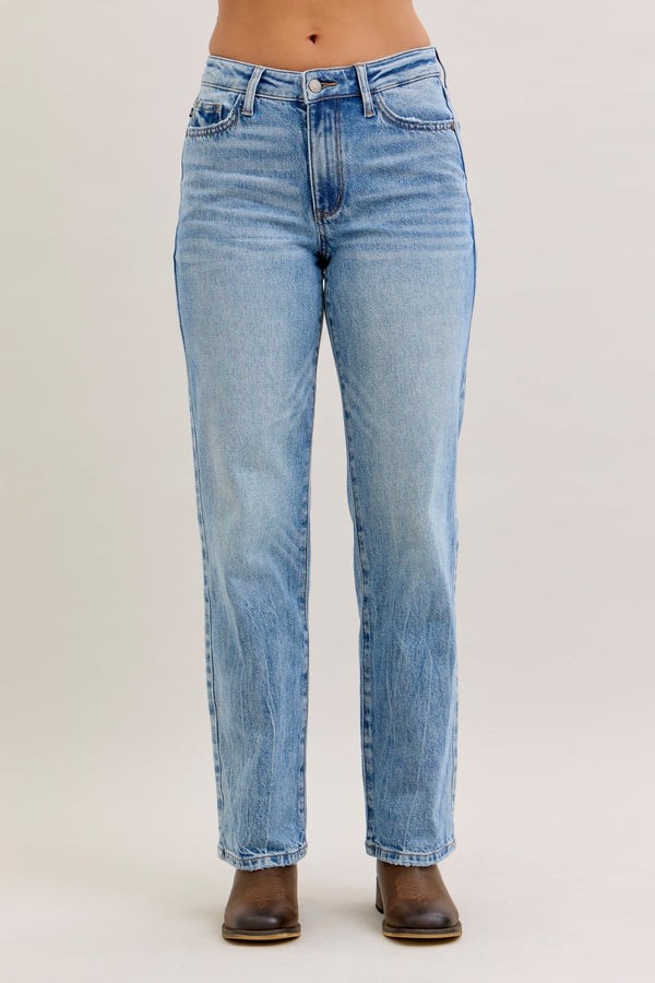 Light blue jeans worn by a person on a plain background