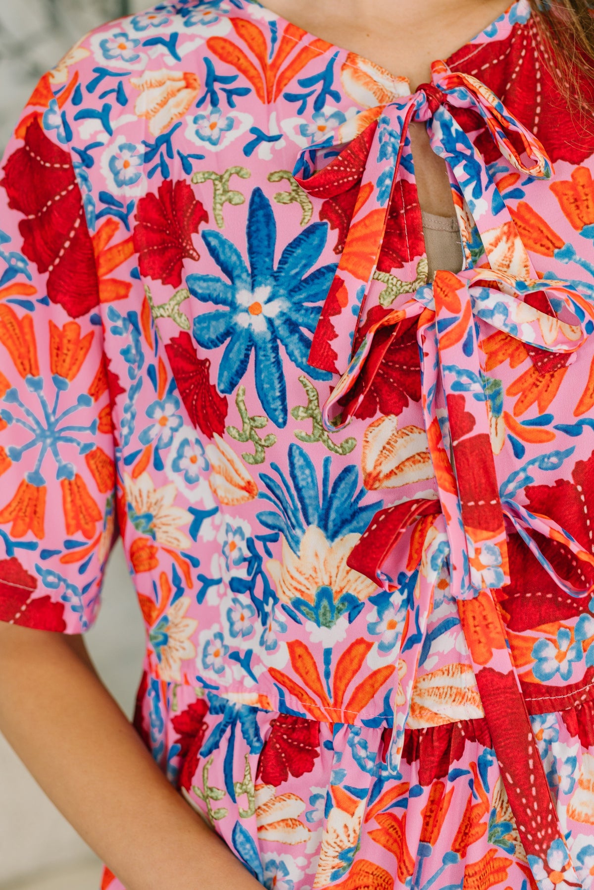 Colorful floral dress with a vibrant pattern on a plain background