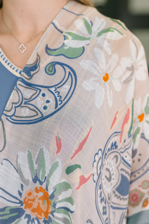 Close-up of a person wearing a floral-patterned garment with colorful designs.