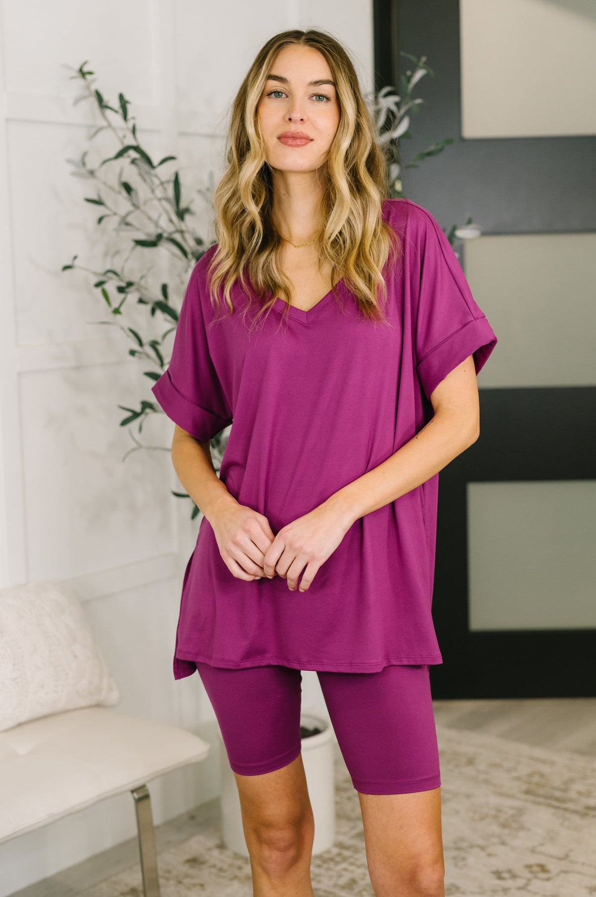 Woman wearing a purple outfit in a home setting