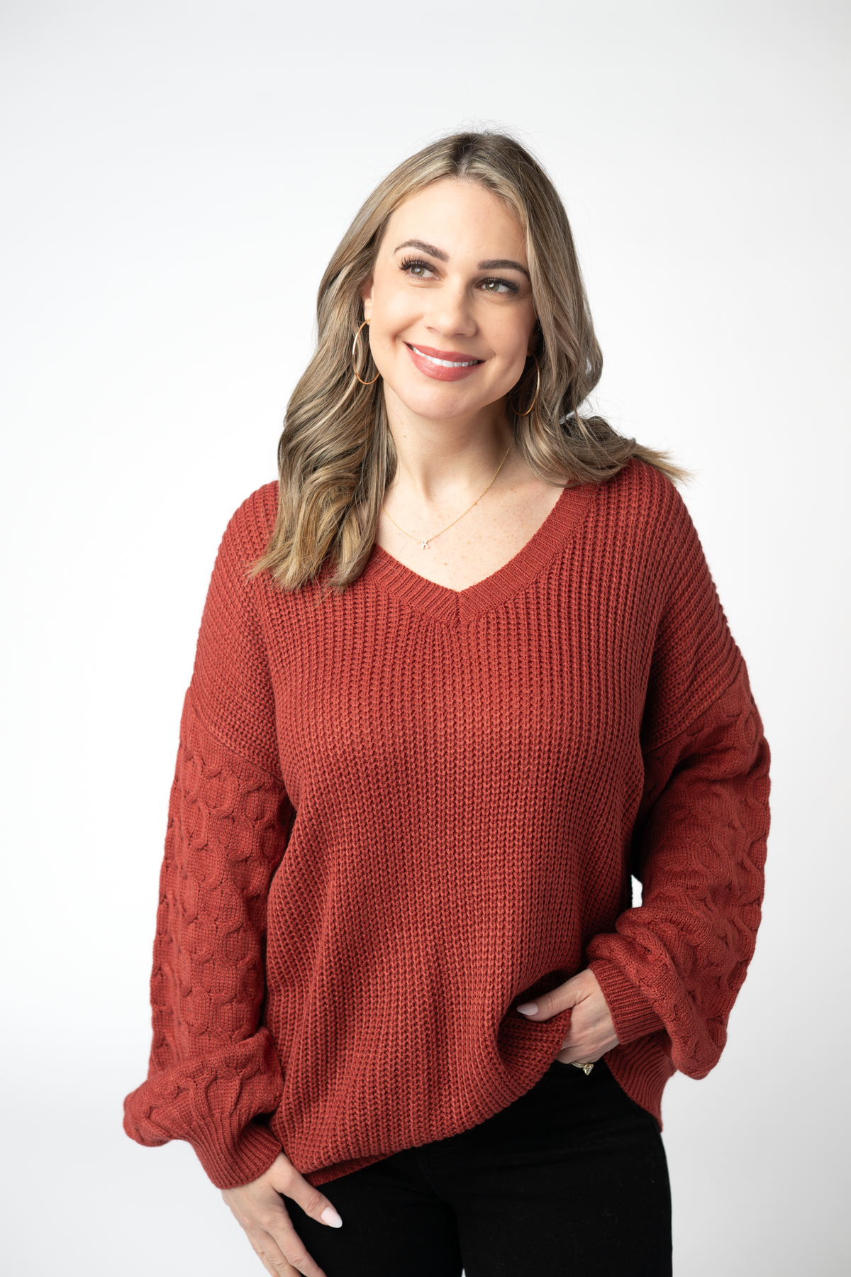 Woman wearing a red sweater on a white background