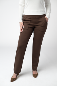 Brown pants worn by a person on a white background
