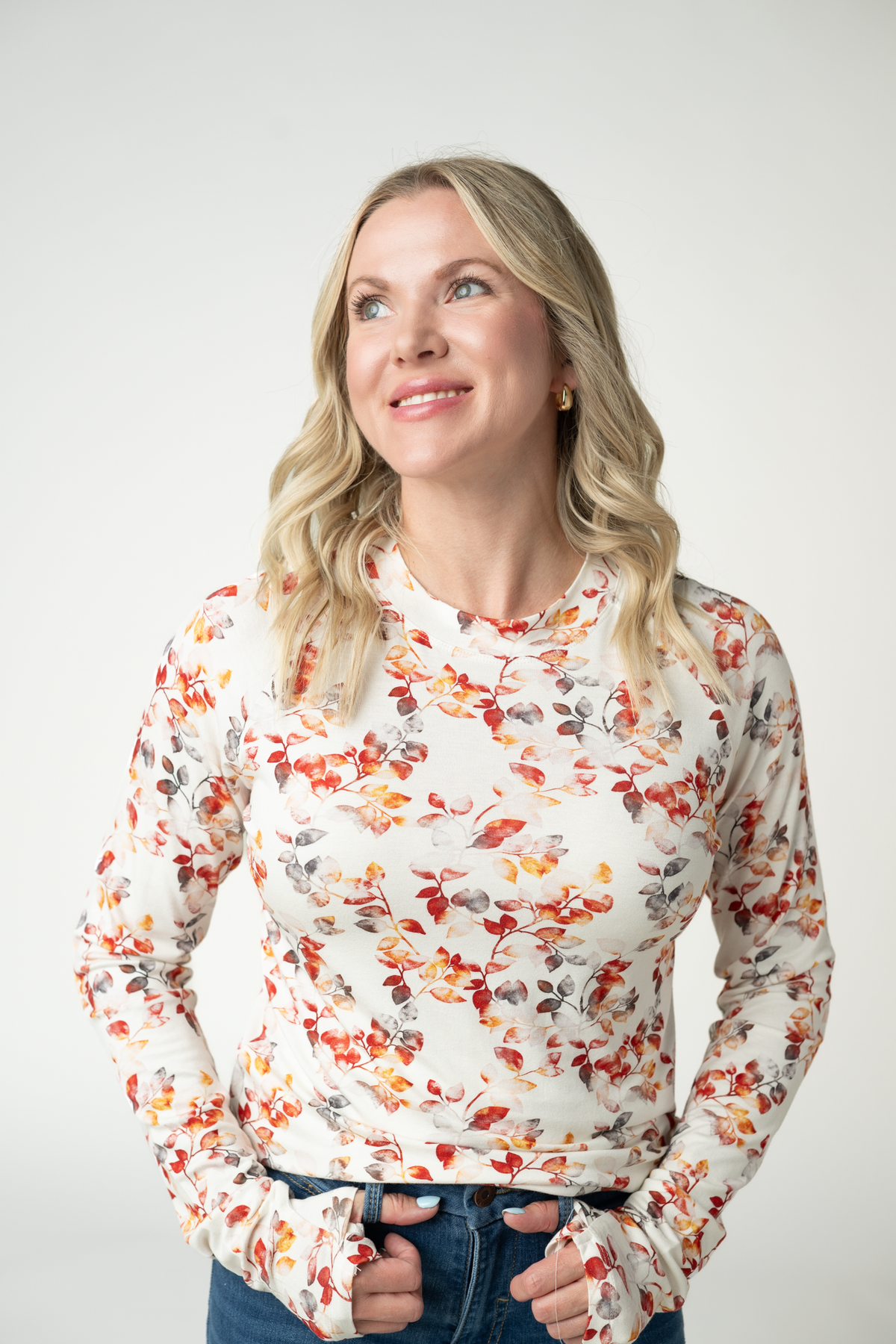 Woman wearing a floral blouse against a plain background
