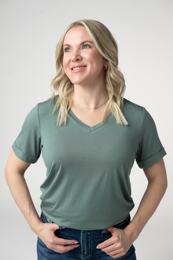 Woman wearing a green t-shirt against a plain background