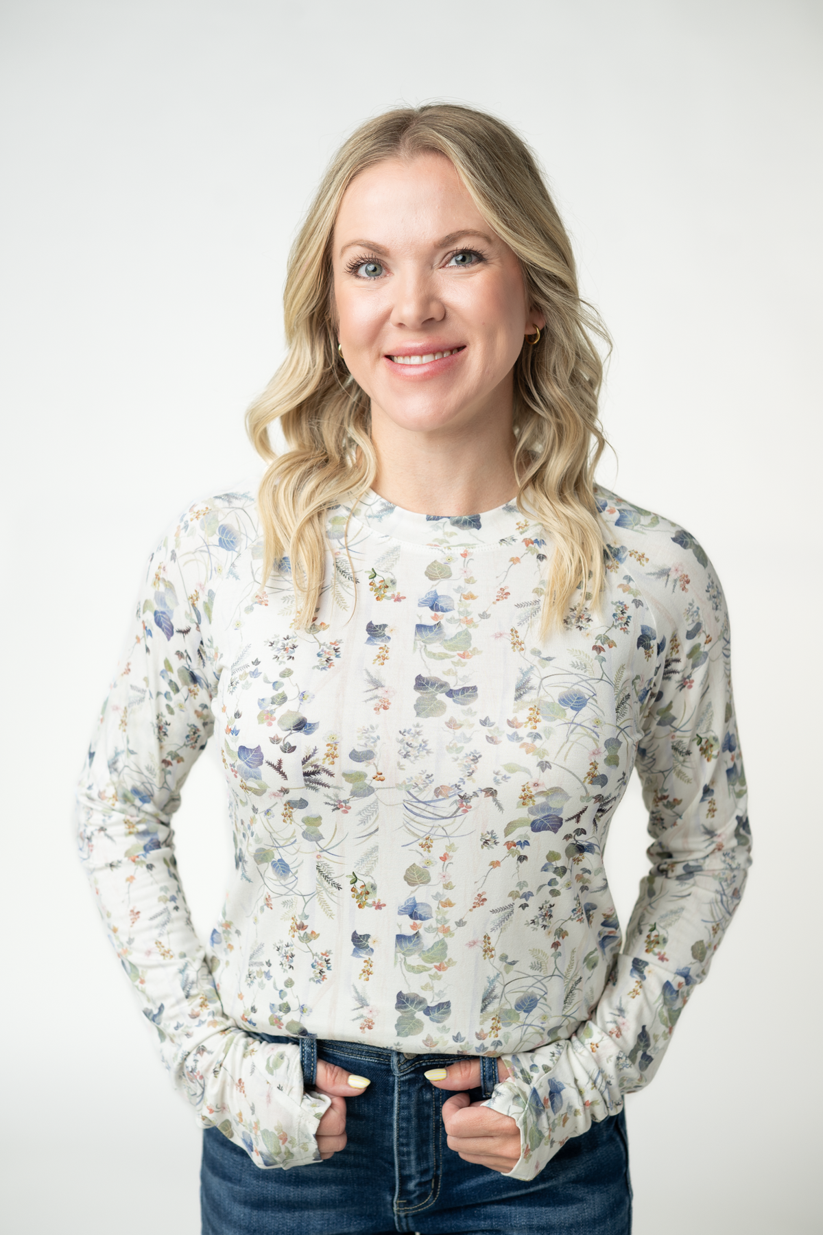 Woman wearing a floral blouse against a white background