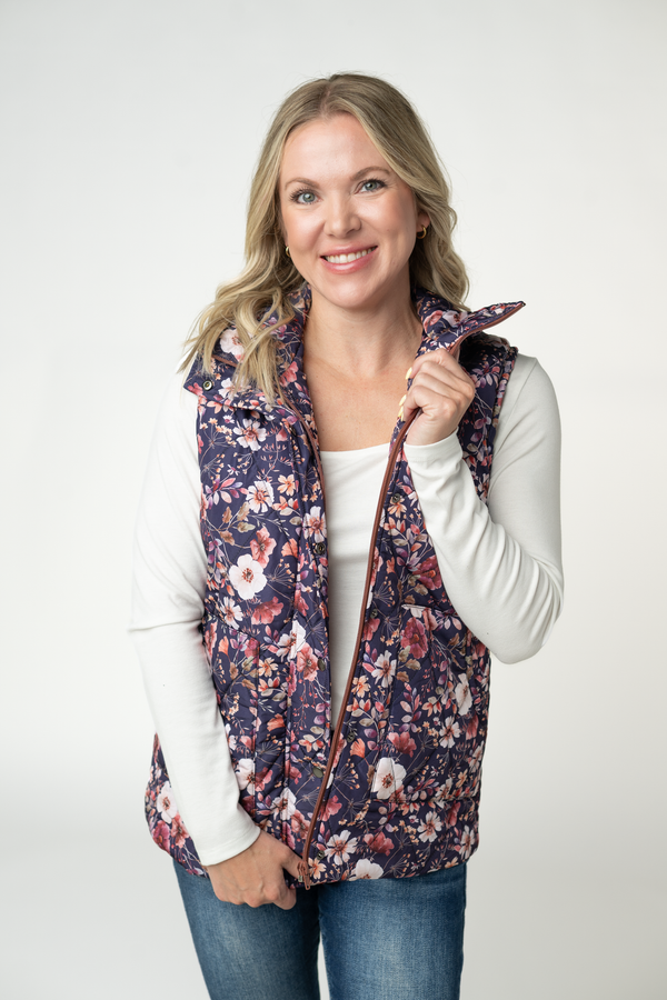 Woman wearing a floral patterned vest on a white background