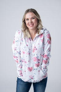 Woman wearing a floral blouse with a plain background