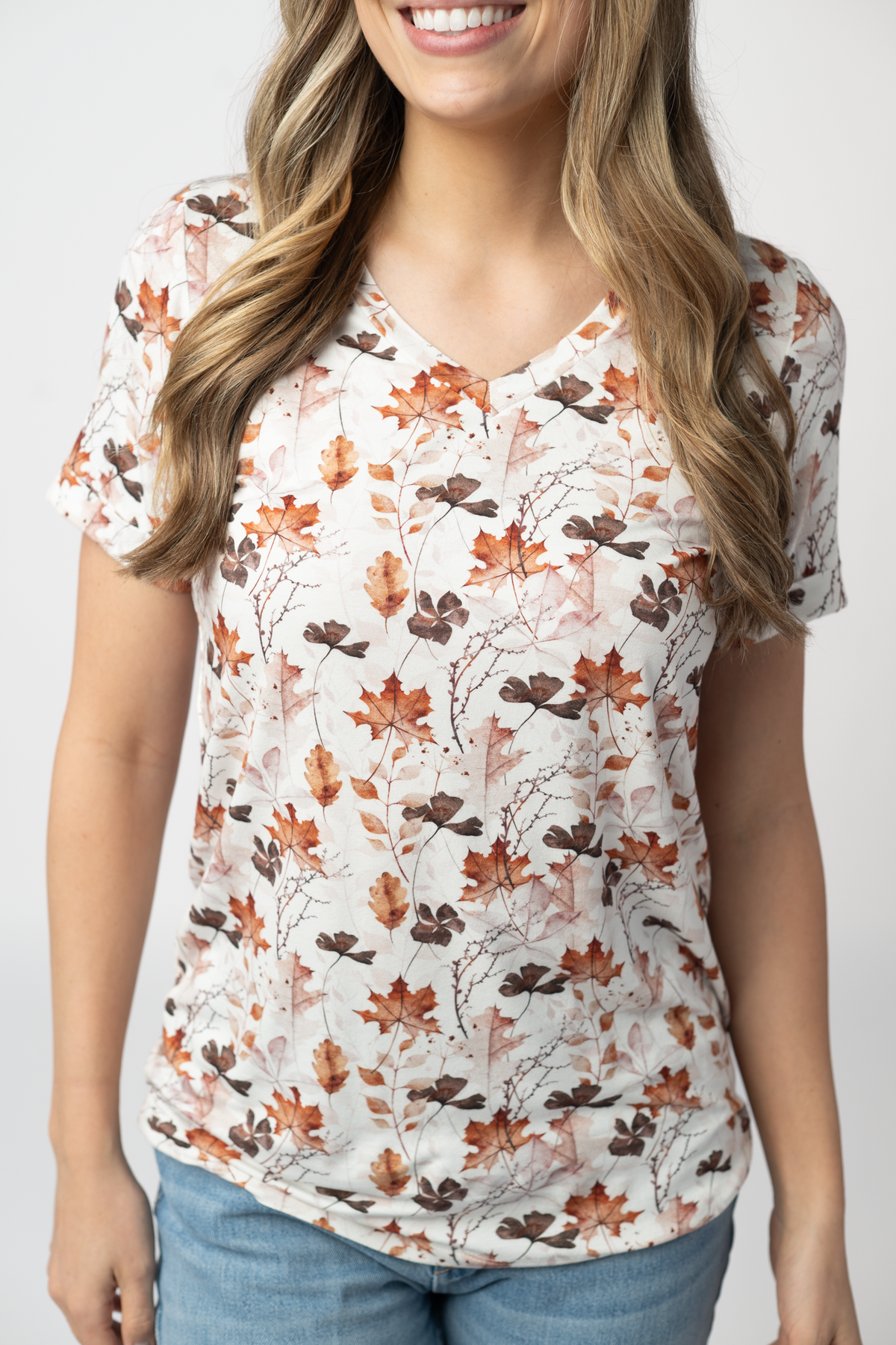Woman wearing a floral patterned top with a plain background