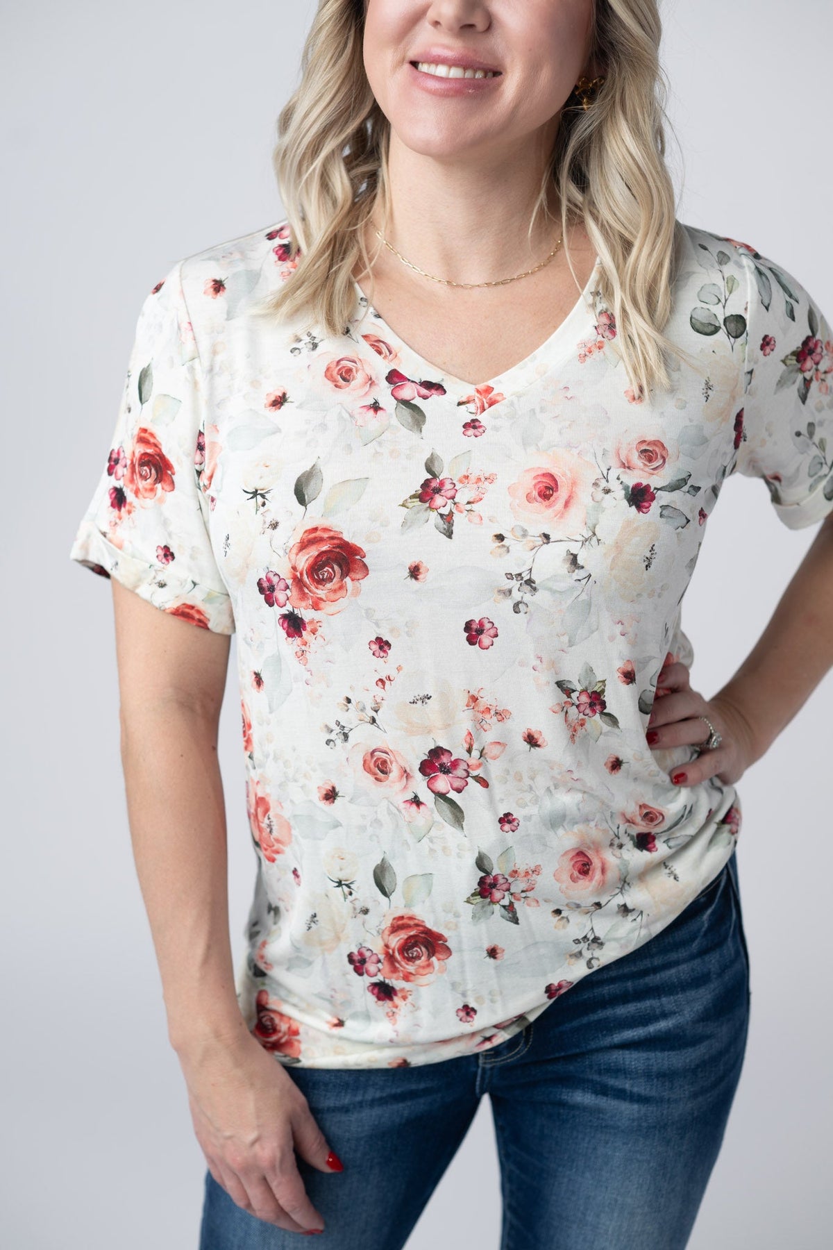 Woman wearing a floral print shirt against a plain background