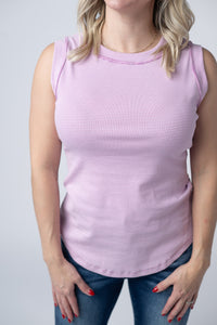 Person wearing a pink striped sleeveless top against a plain background