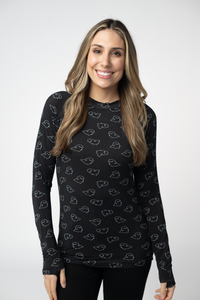 Woman wearing a black long-sleeve shirt with a pattern on a white background