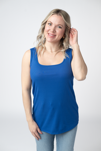 Woman wearing a blue tank top against a white background