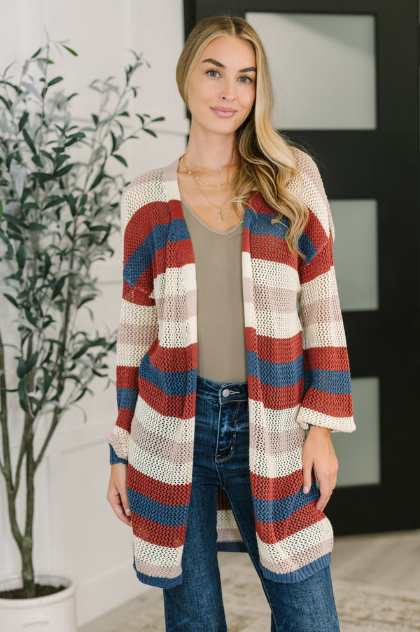 Woman wearing a striped cardigan in a home setting
