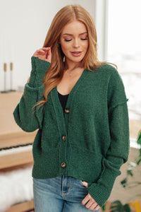 Woman wearing a green cardigan in an indoor setting