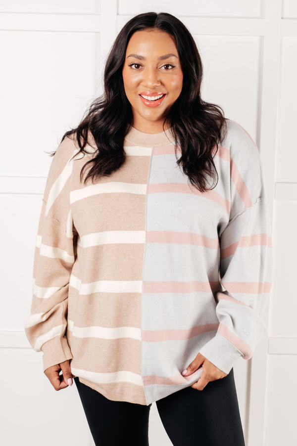 Woman wearing a striped sweater against a white background