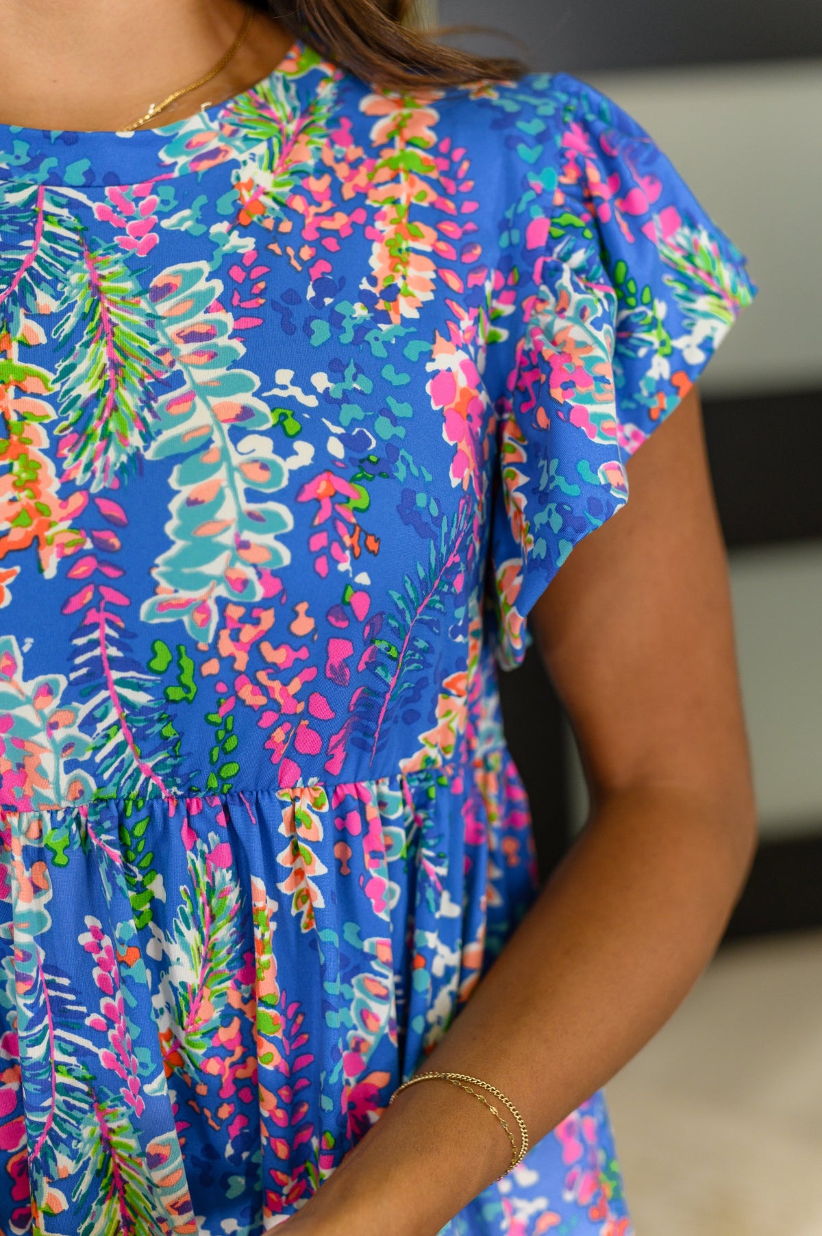 Close-up of a colorful floral dress with a blurred background