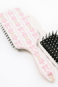 Hairbrush with floral design on a white background
