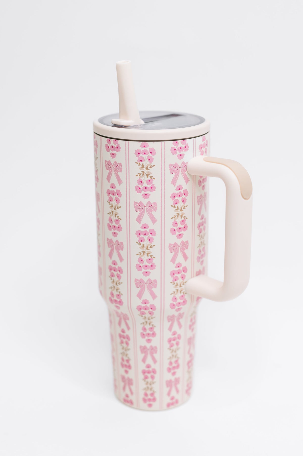 Tumbler with pink bow pattern on a white background