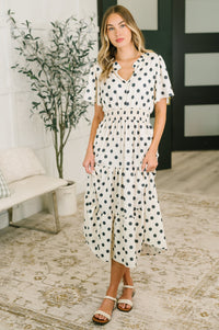 Woman wearing a polka dot dress in a home setting