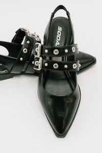 Black pointed-toe shoes with studded details on a white background