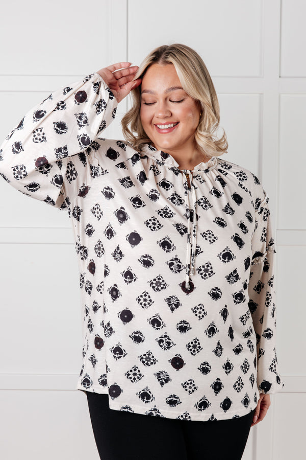 Woman wearing a white hoodie with black paw print pattern against a white background