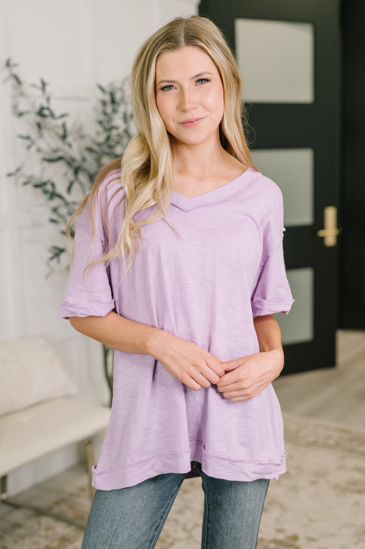 Woman wearing a purple tunic in an indoor setting