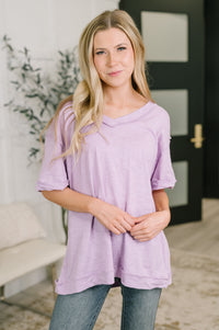 Woman wearing a purple tunic in an indoor setting